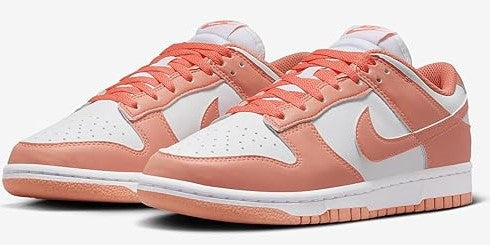 Women's Nike Dunk Low pair with coral leather overlays and white lace-up panels