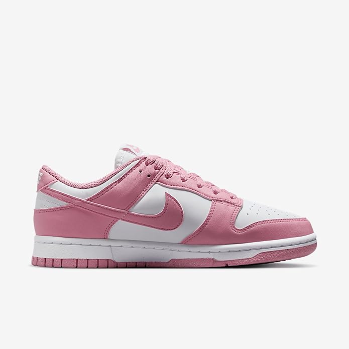 Pink and white low-top sneakers with lace-up front, stitched panels, and thick rubber sole