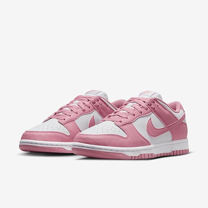 Pair of pink and white low-top lace-up sneakers with Nike swoosh and cushioned midsole