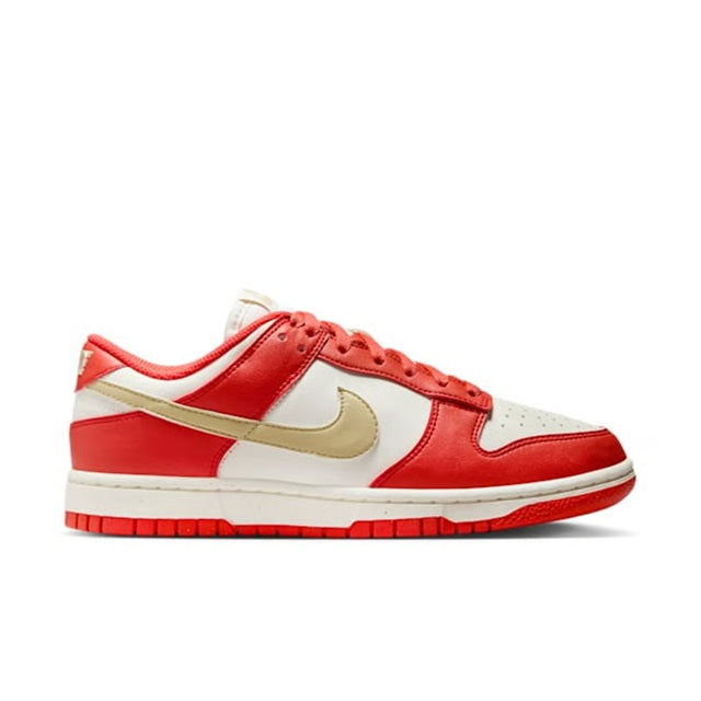 Low-top Nike Dunk sneakers side view with red uppers, white panels, and gold swoosh