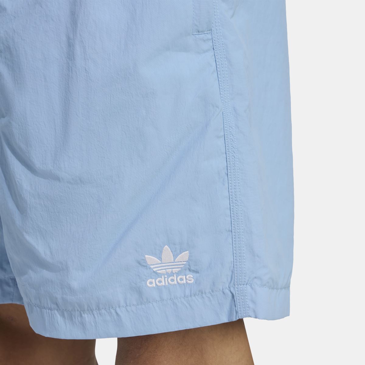 Light blue shorts close-up with adidas logo and trefoil on lower leg