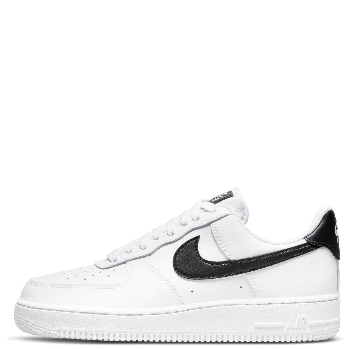 White Nike low-top sneakers with black swoosh and black heel panel, lace-up.