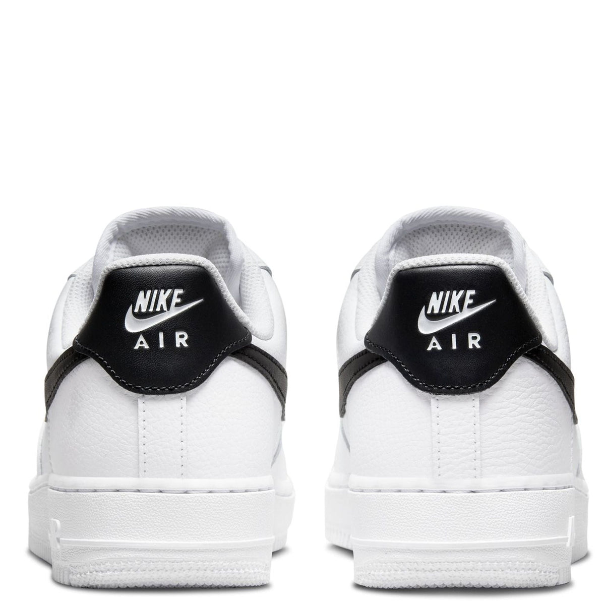 White Nike sneakers with black Nike Air heel tabs and white rubber sole.