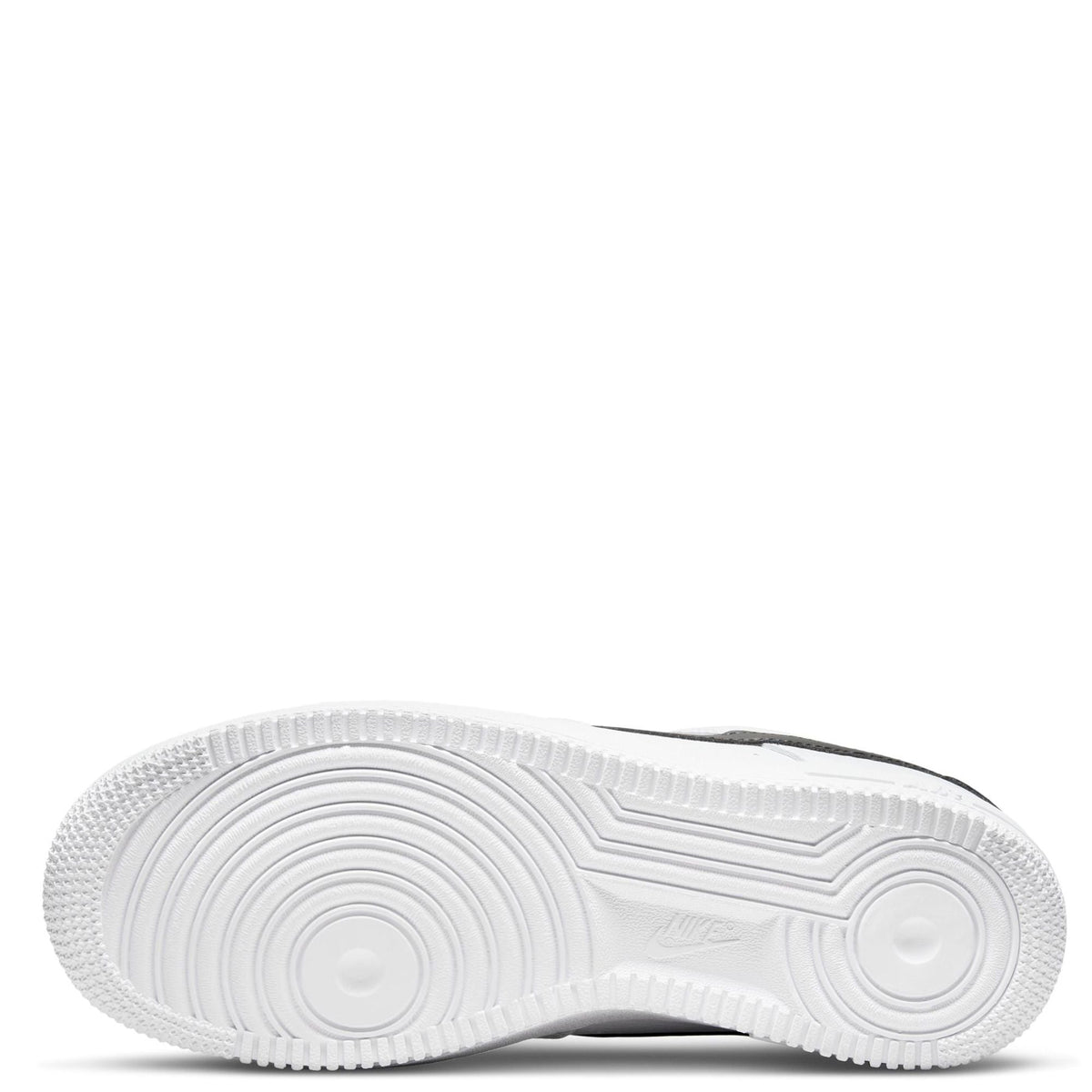 White rubber sneaker outsole with circular tread pattern, Nike mark.