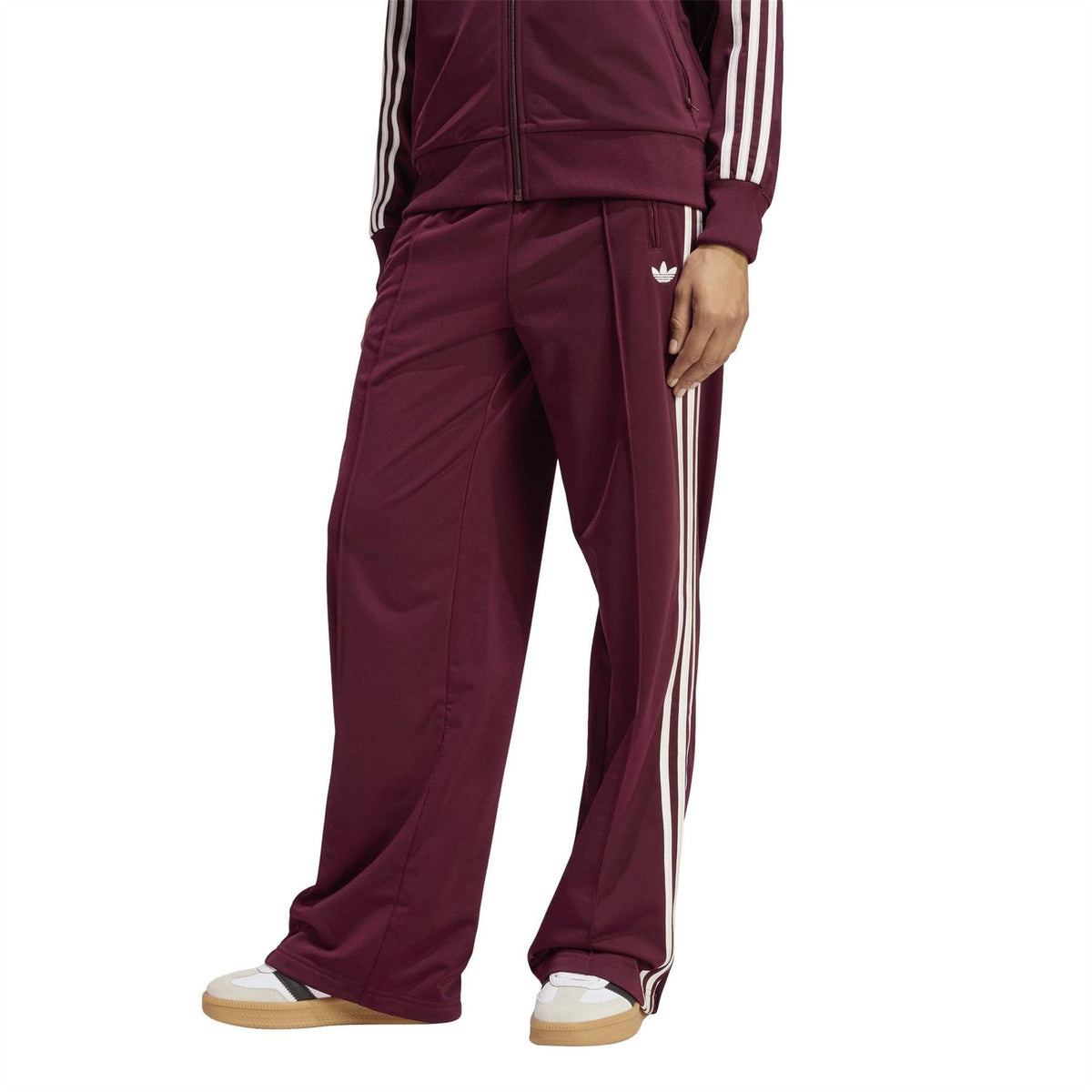 Maroon track pants with white side stripes and zip pocket at the front