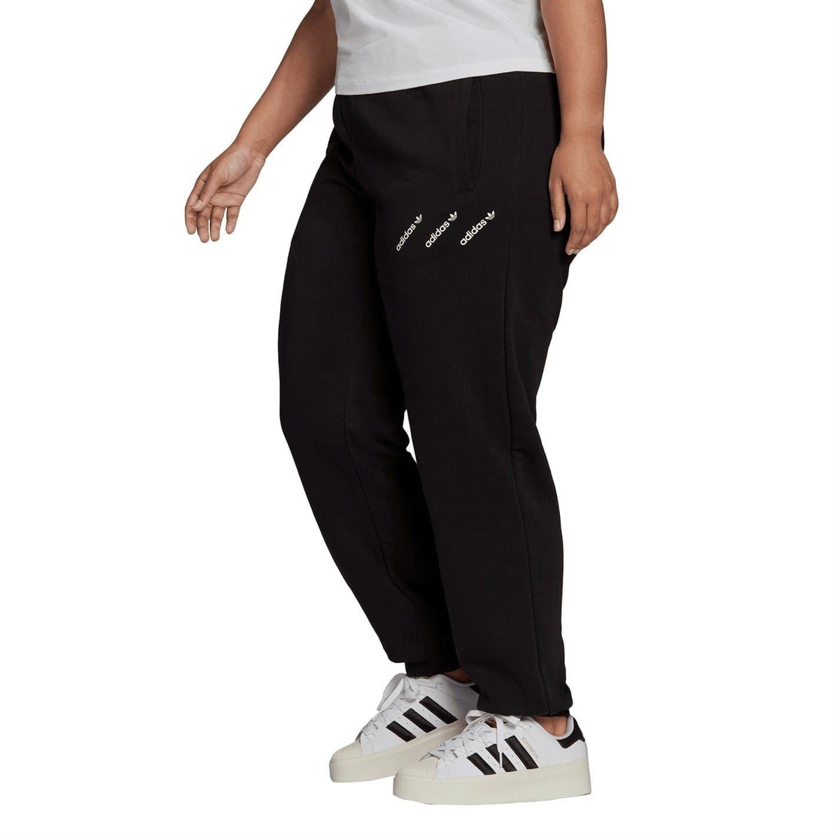 Black track sweatpants with drawstring waist, tapered fit, and adidas side logo
