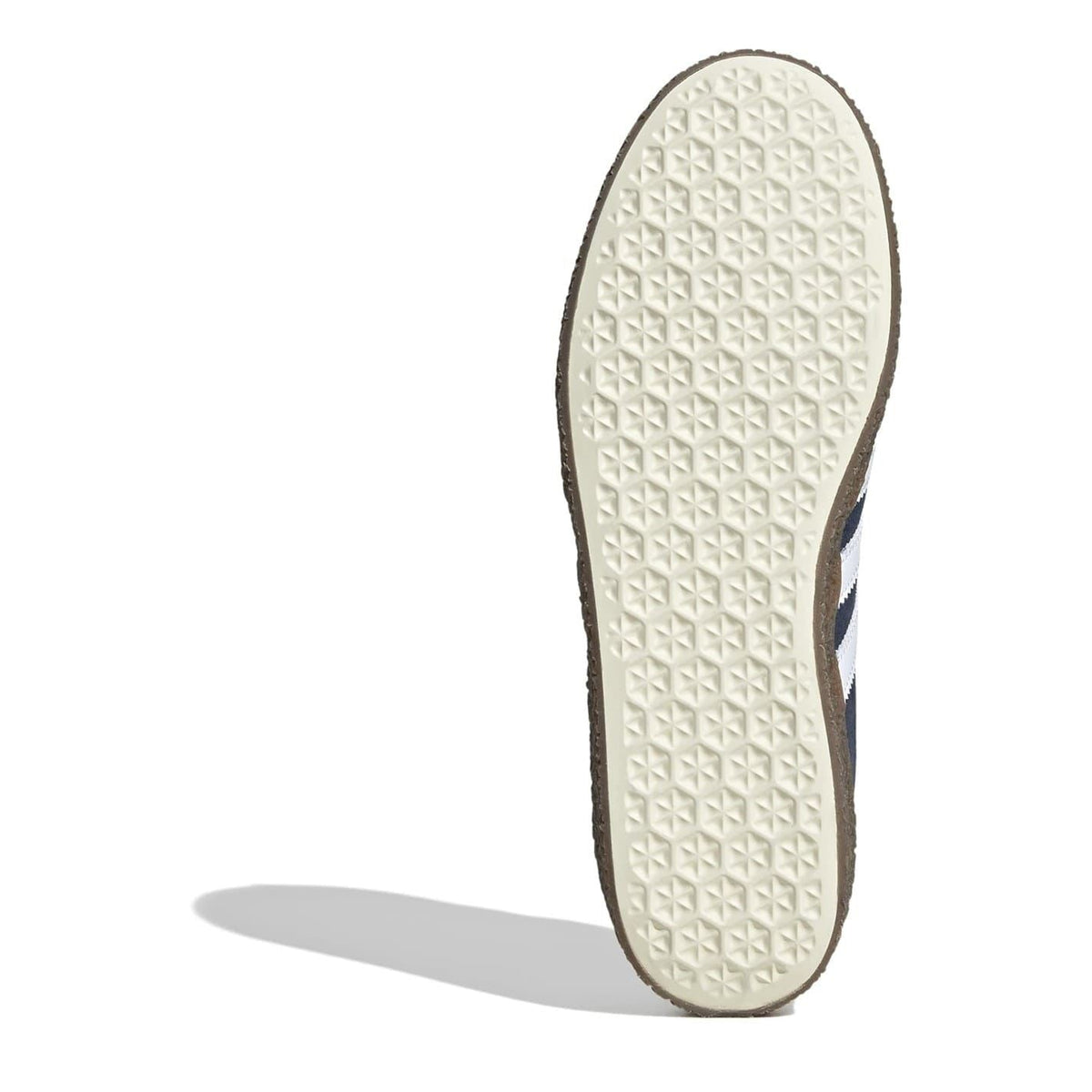 White textured outsole of navy trainers with dark border