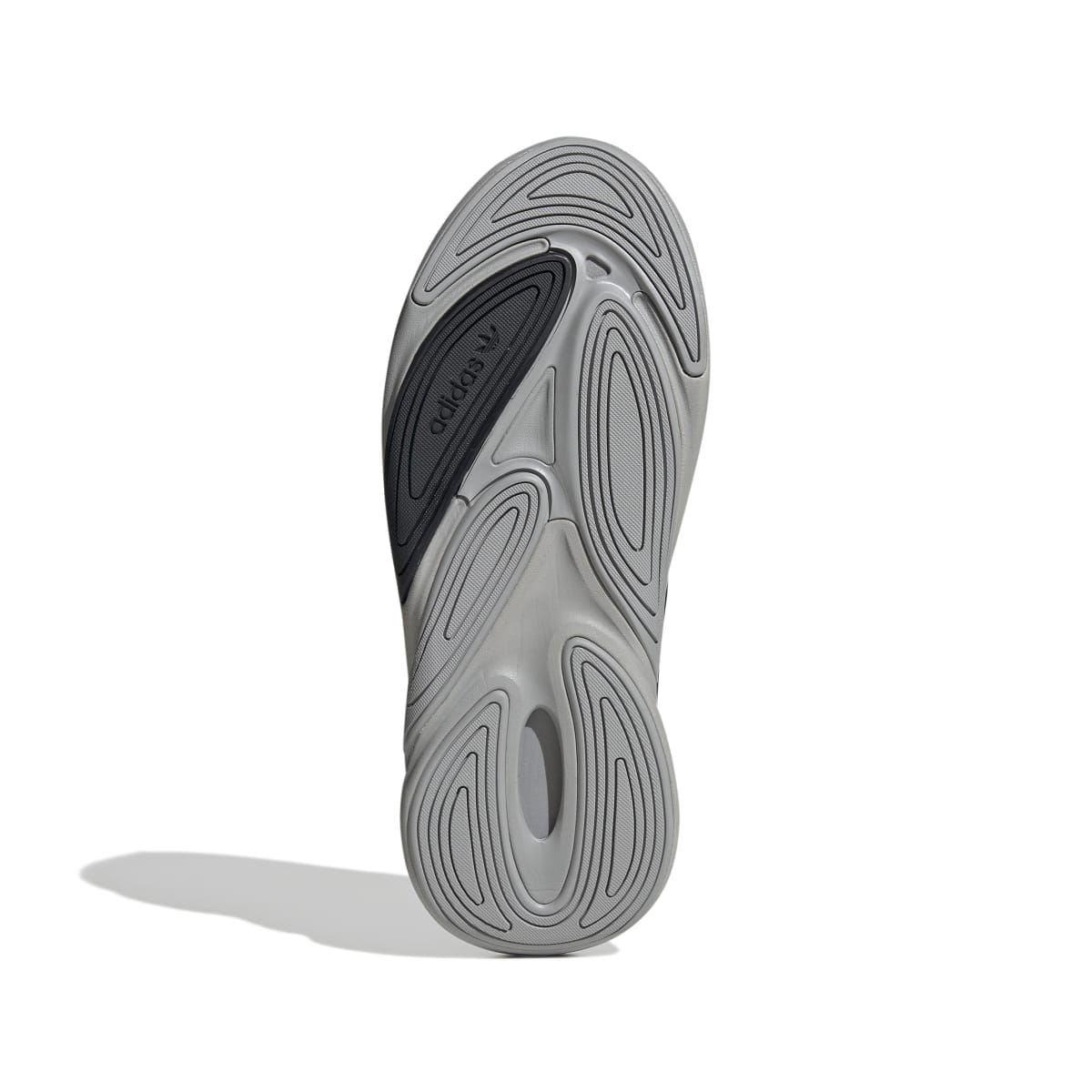 Shoe outsole side profile with textured tread pattern and gray detailing