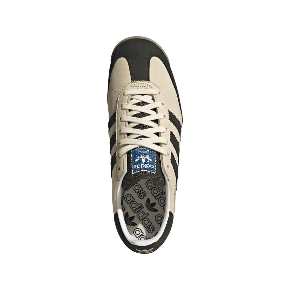 Beige adidas sneaker with black heel, white laces, and logo on the tongue