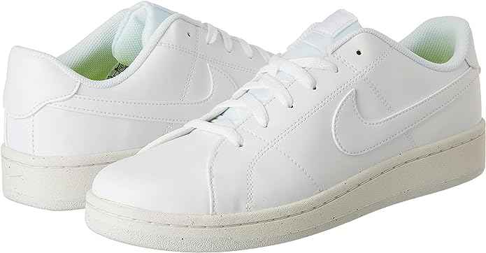Pair of white low-top lace sneakers with Nike swoosh and mint-green lining accents