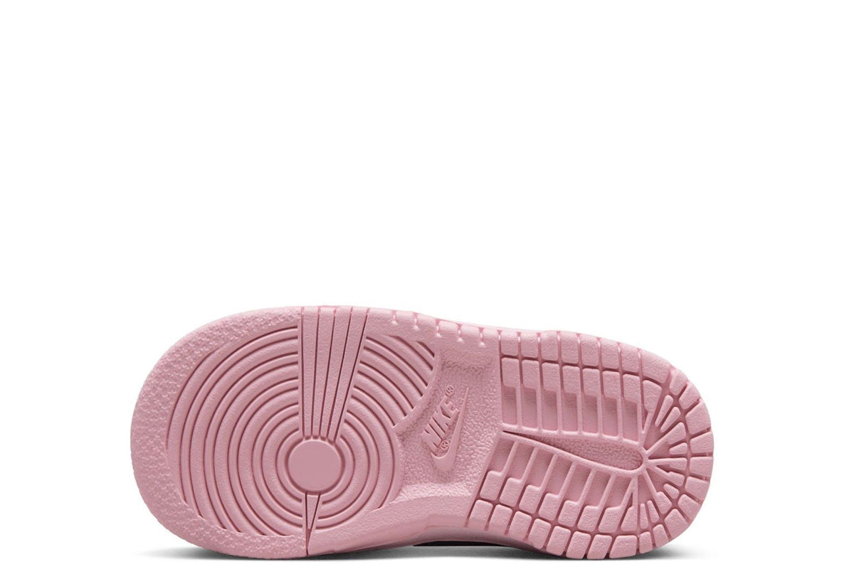 Kids' Nike Dunk Low sneakers, pink rubber outsole tread underside.