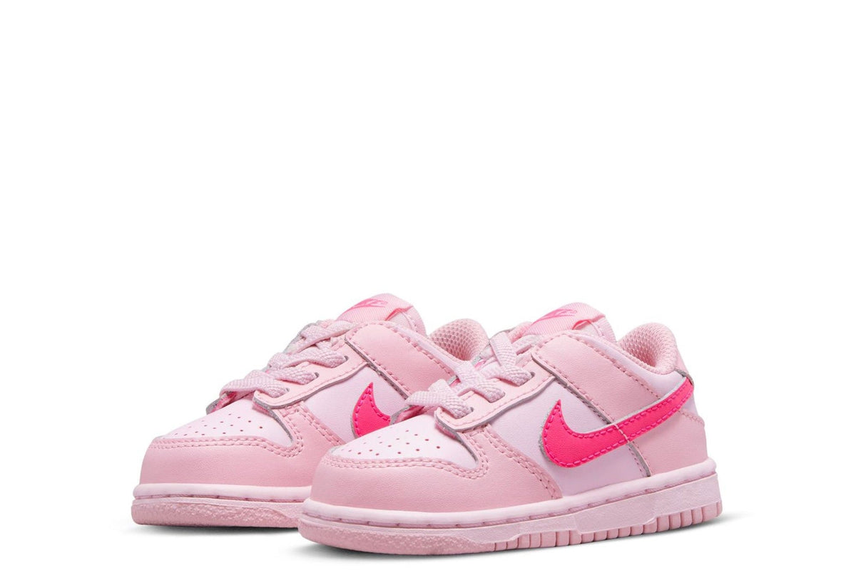Kids' Nike Dunk Low sneakers, pair view in light pink with pink accents.