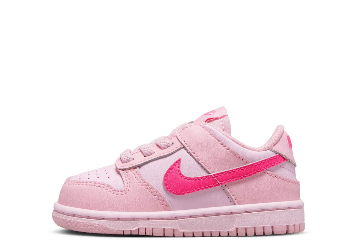 Kids' Nike Dunk Low sneakers in light pink with pink swoosh and laces.