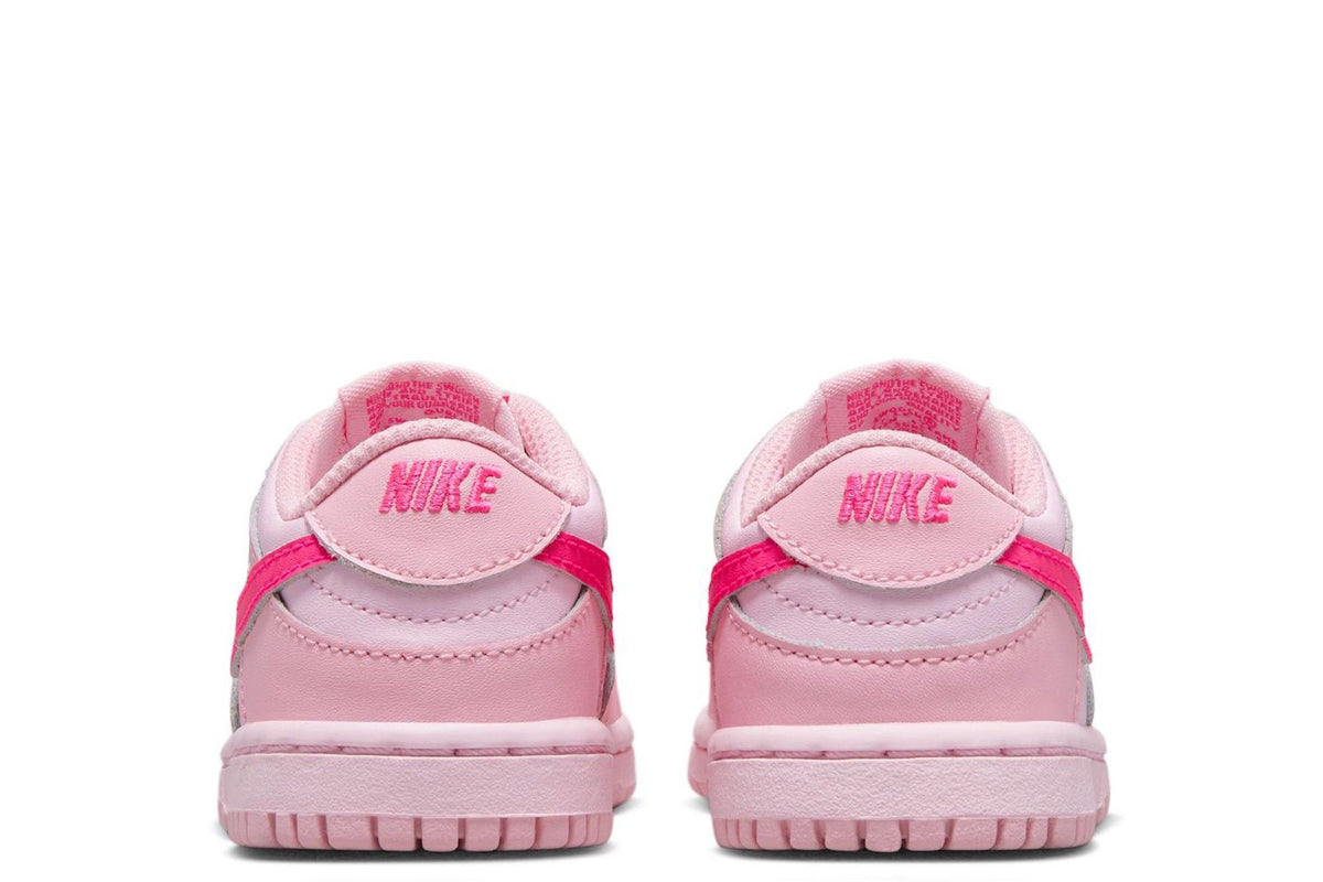 Kids' Nike Dunk Low sneakers, heel view in light pink with pink outsole trim.
