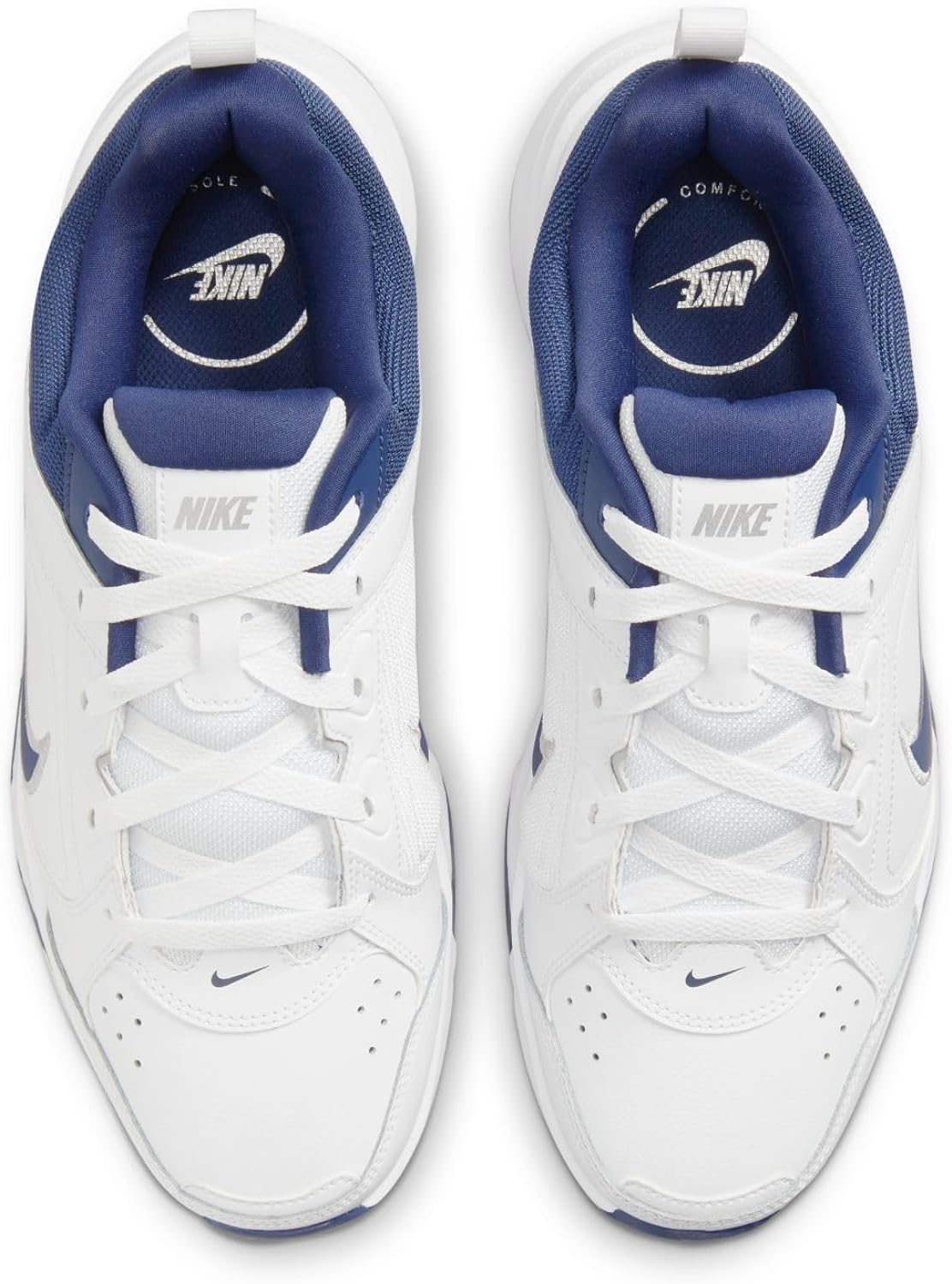 White lace-up Nike sneakers with navy inner lining and Nike logo on the tongue