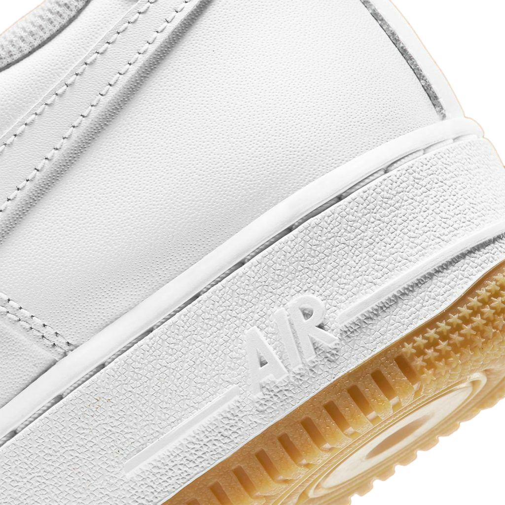 Nike Air Force 1 midsole close-up with raised AIR logo on white leather