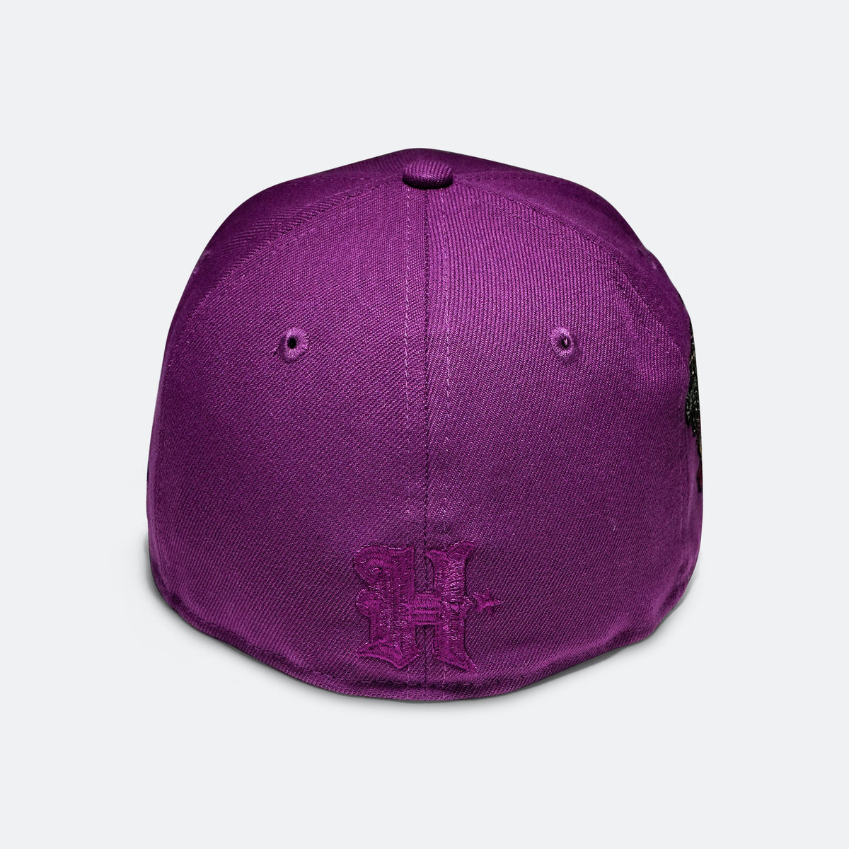 Purple baseball cap with small embroidered H logo on the back