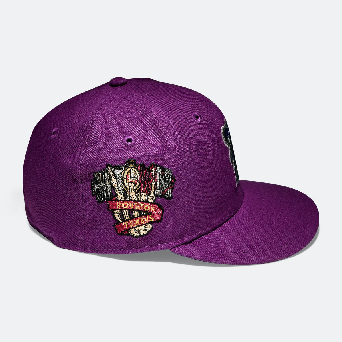 Purple baseball cap with embroidered Houston Texans logo patch on the side