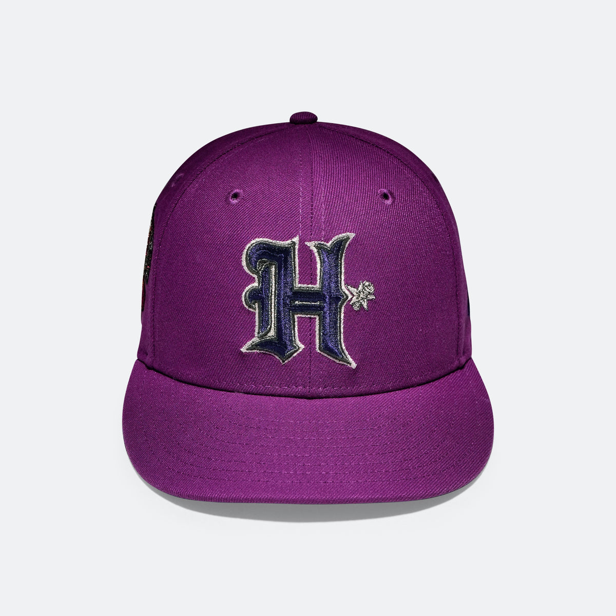 Purple baseball cap with embroidered H logo on the front panel
