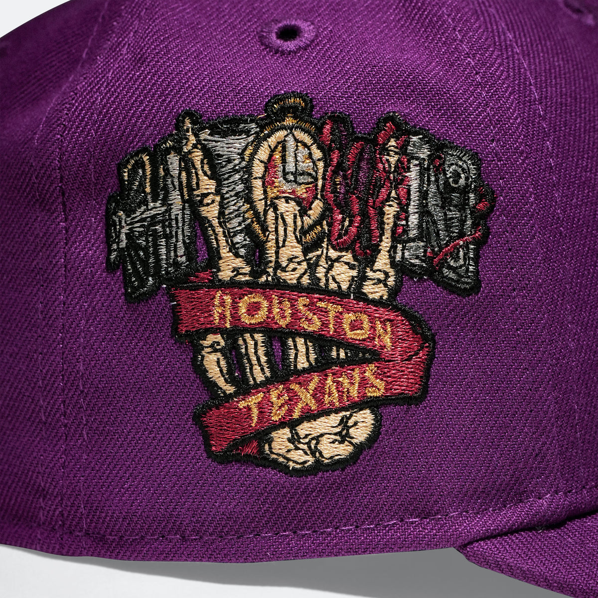 Close-up of Houston Texans logo patch on a purple baseball cap