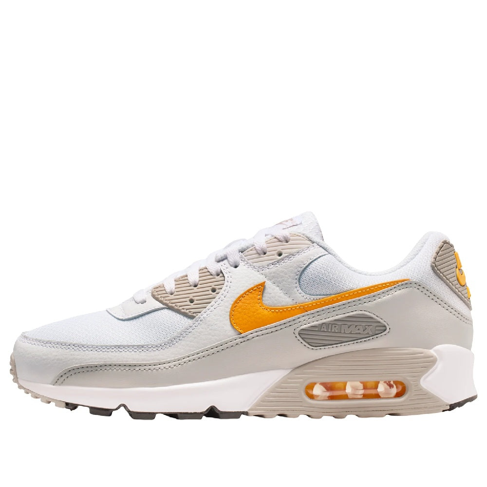 Nike Air Max 90 sneakers in white with orange swoosh and Air unit cushioning