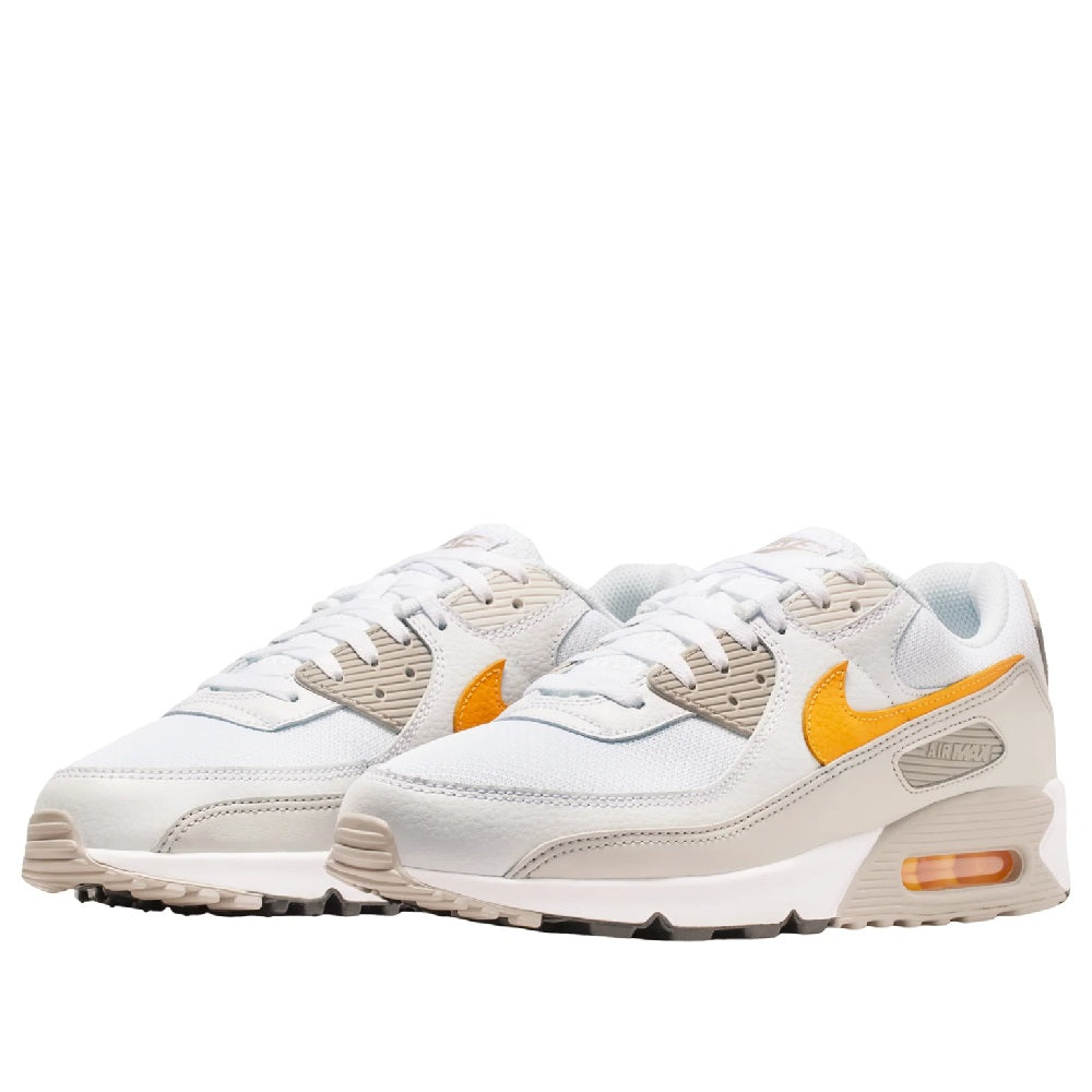 Nike Air Max 90 sneakers pair, white with orange swooshes and beige lace panels