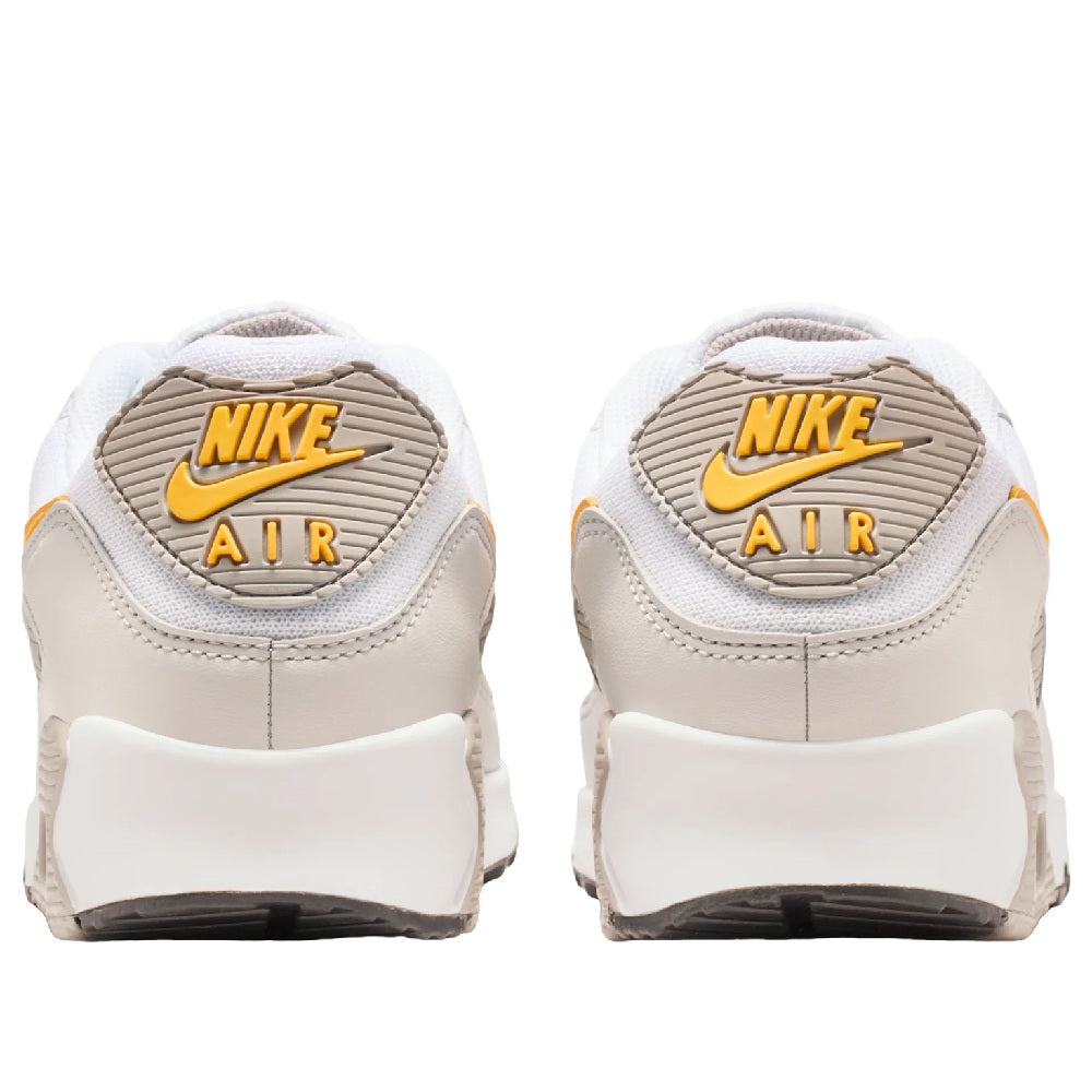 Nike Air Max 90 sneakers heel view, white back with Nike Air label and orange details