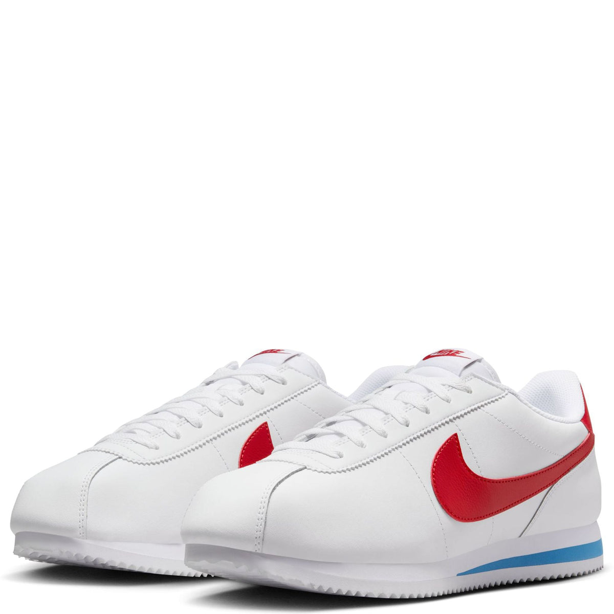 Pair of white Nike Cortez sneakers with red Swoosh and blue stripe on the midsole