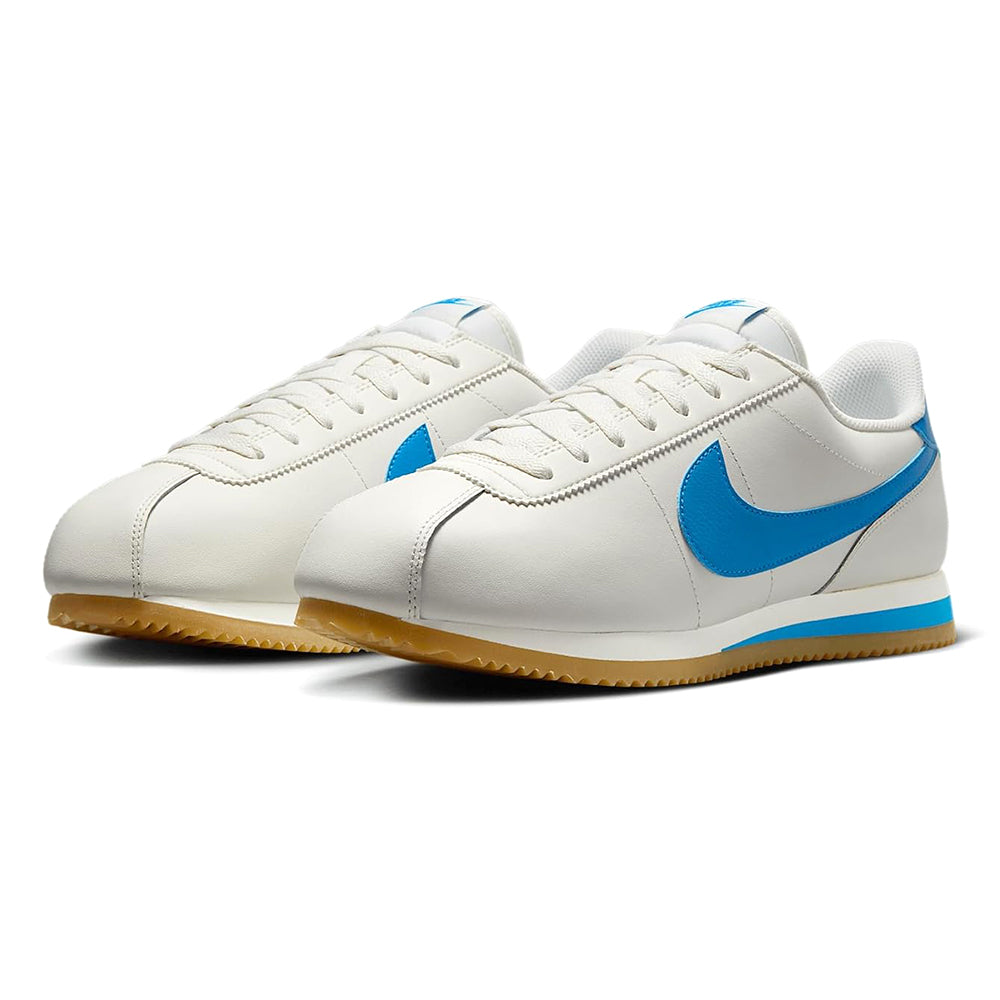 Nike low-top sneakers, white leather with blue swoosh, gum outsole, lace-up
