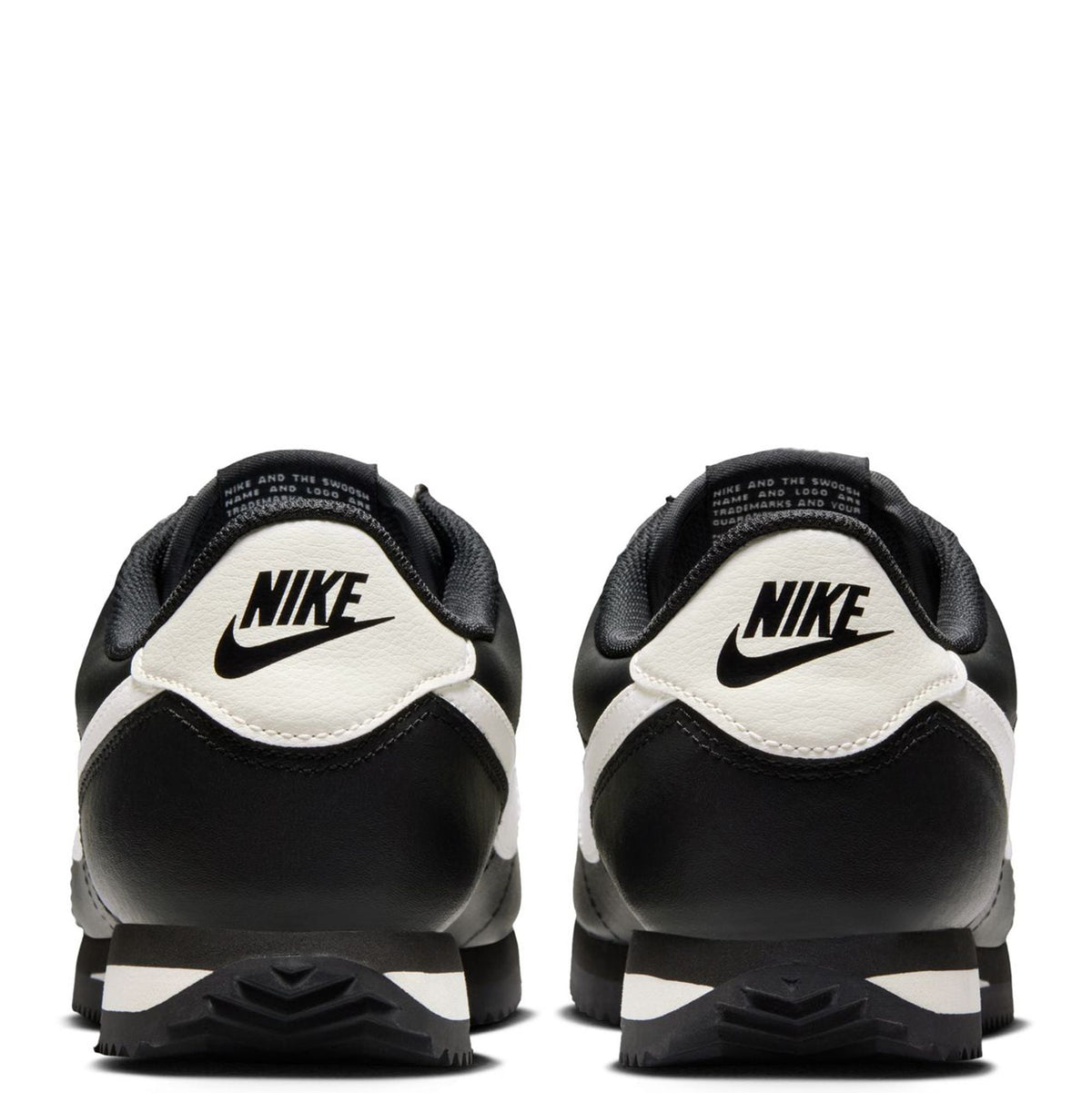 Nike Cortez sneakers heel view with Nike label, black with pale ivory details