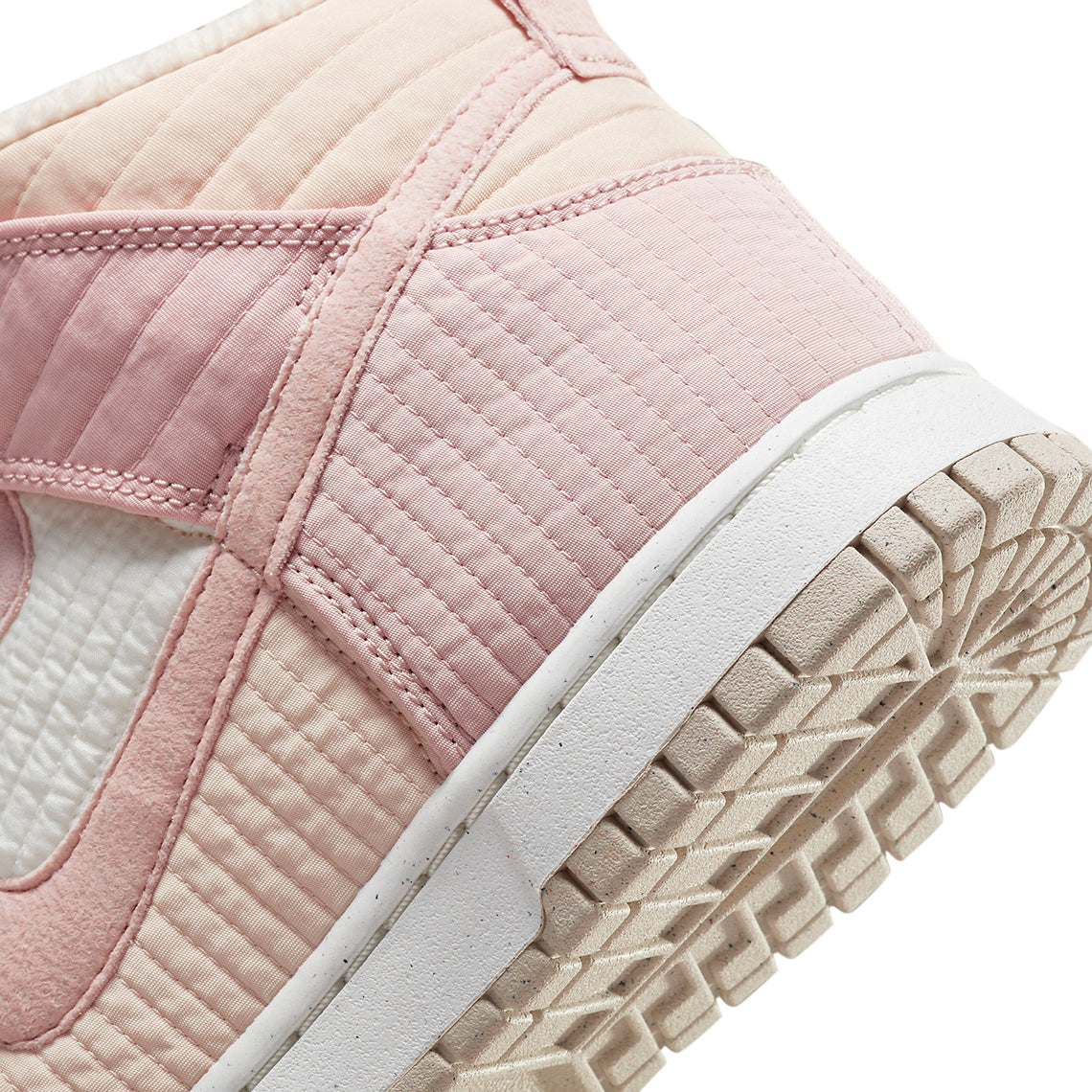 High-top sneaker side view showing quilted pink paneling and stitched trim