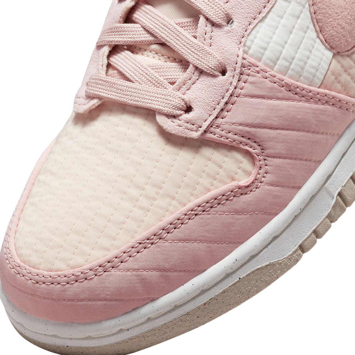 High-top sneaker close-up of pink laces, Nike swoosh, and textured upper