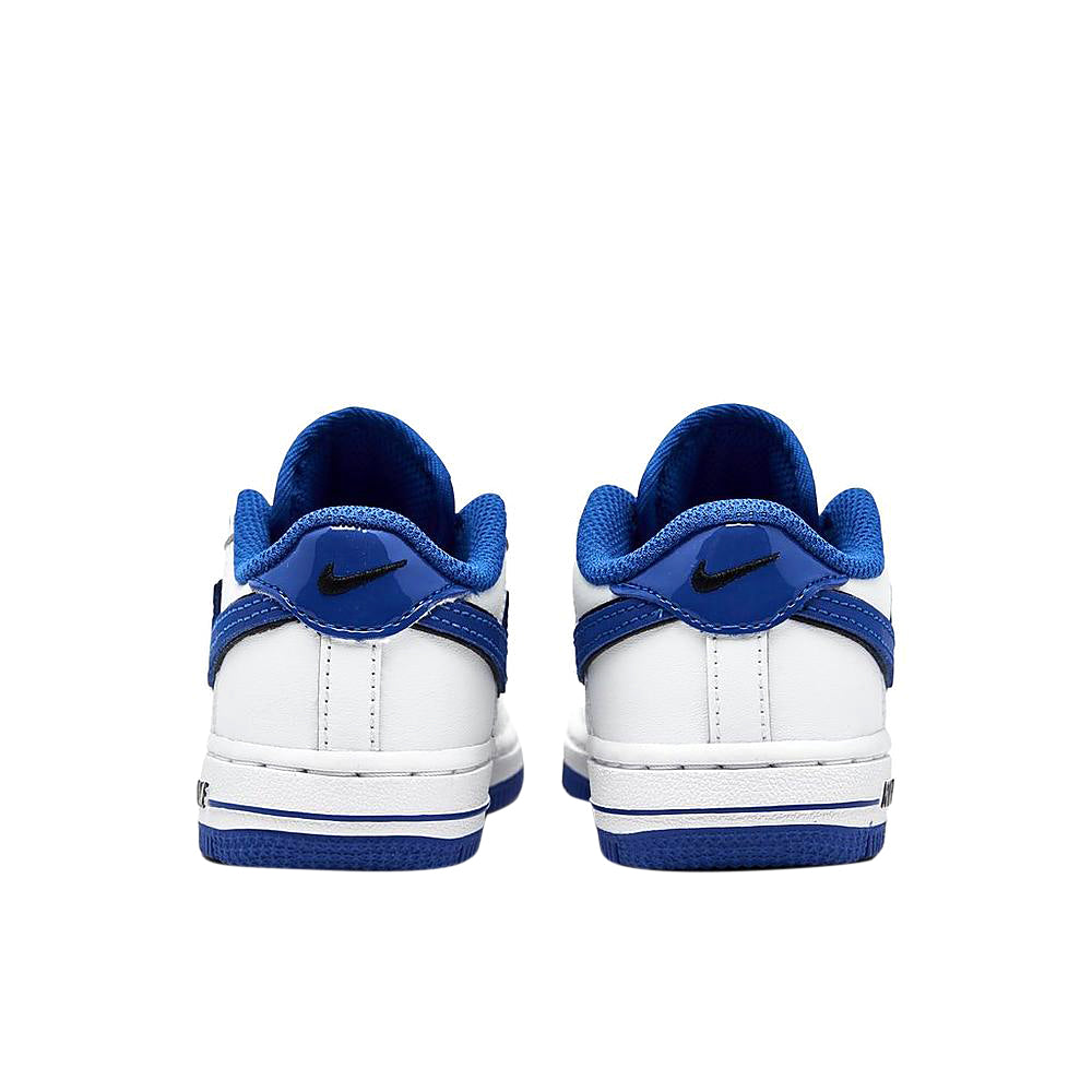 Toddler white low-top sneakers with blue heel detail and blue stripe accent at back