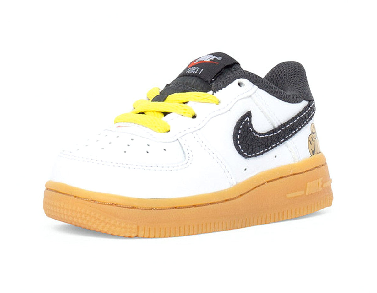 Toddler low-top sneakers, white upper with black swoosh and yellow laces, gum sole