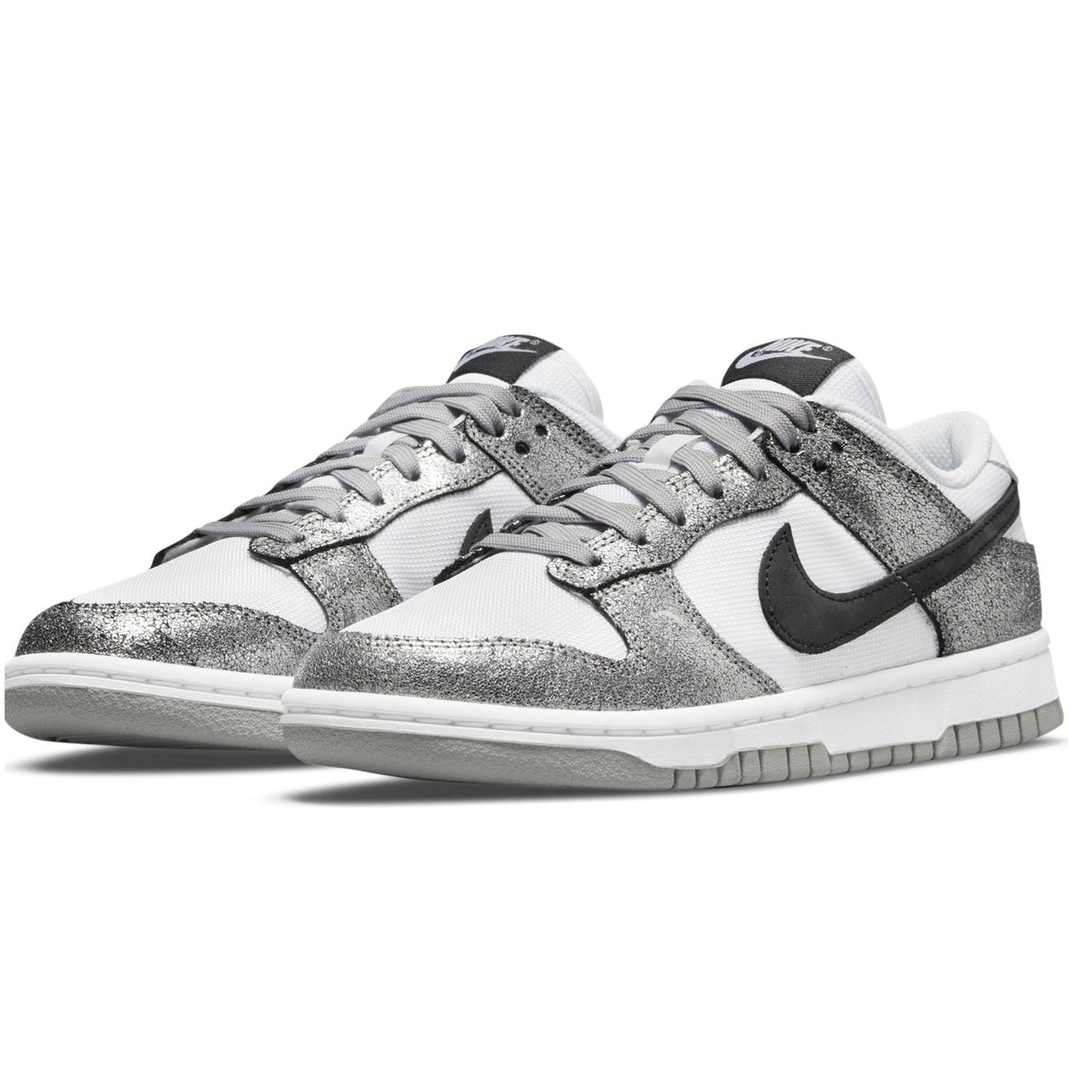 Pair of Nike Dunk Low lace-up sneakers with metallic silver panels and black accents
