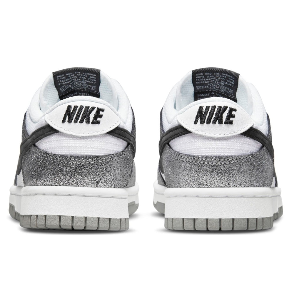 Nike Dunk Low heels with NIKE logo, white midsoles, and dark textured back panels