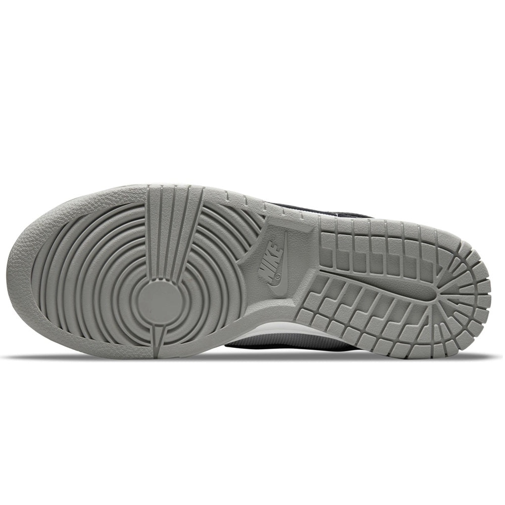 Nike Dunk Low rubber outsole with grid traction pattern in light gray