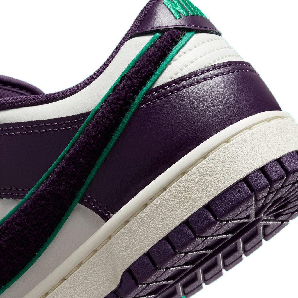 Nike Dunk Low upper close-up, green stitched swoosh on purple leather