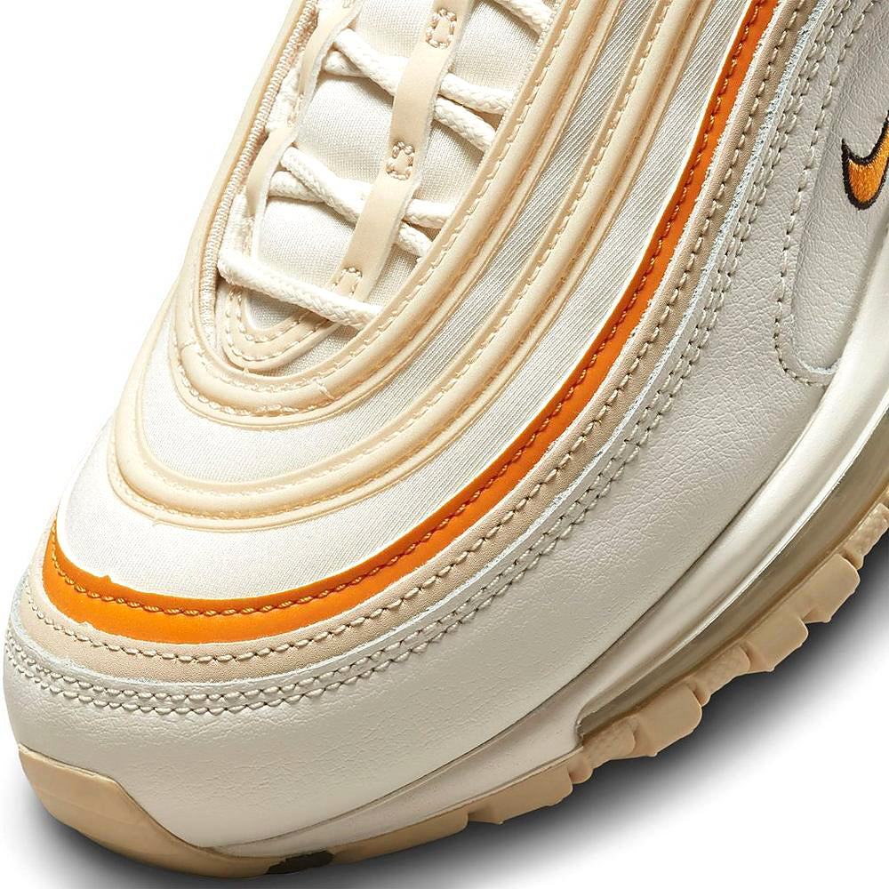 Women's Nike Air Max 97 upper detail, cream laces with orange edge stitching and wave lines
