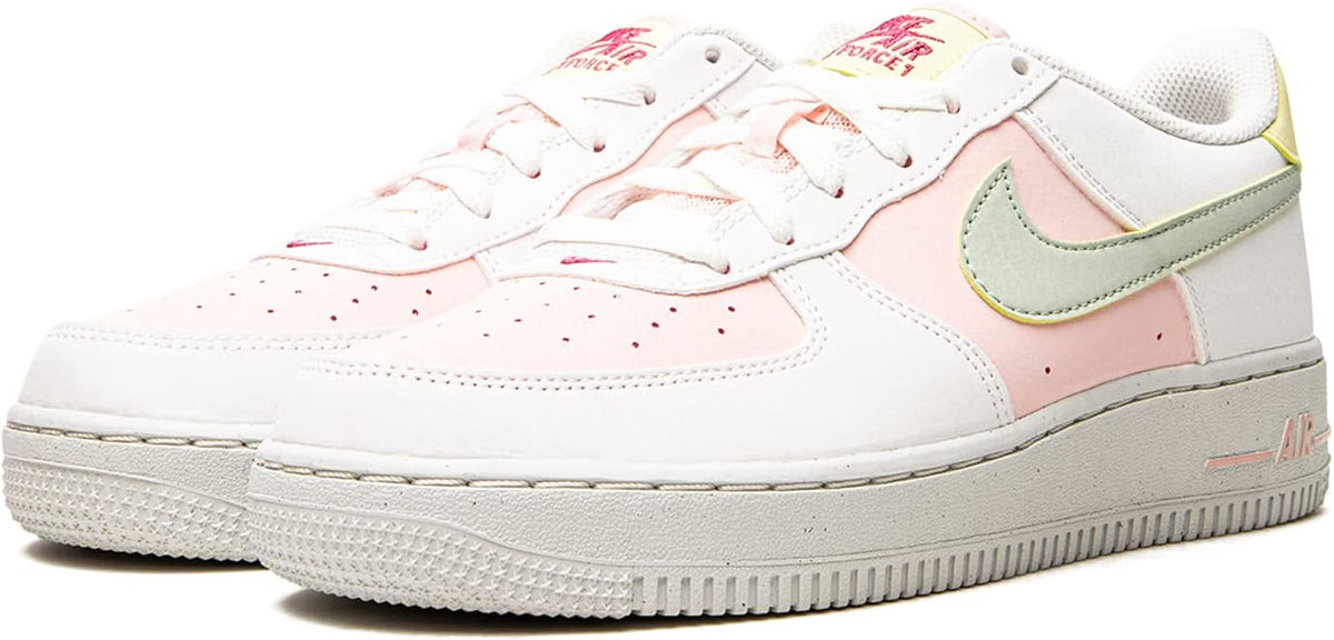 Big kid white sneakers with mint swoosh and pink quarter panel, lace-up.
