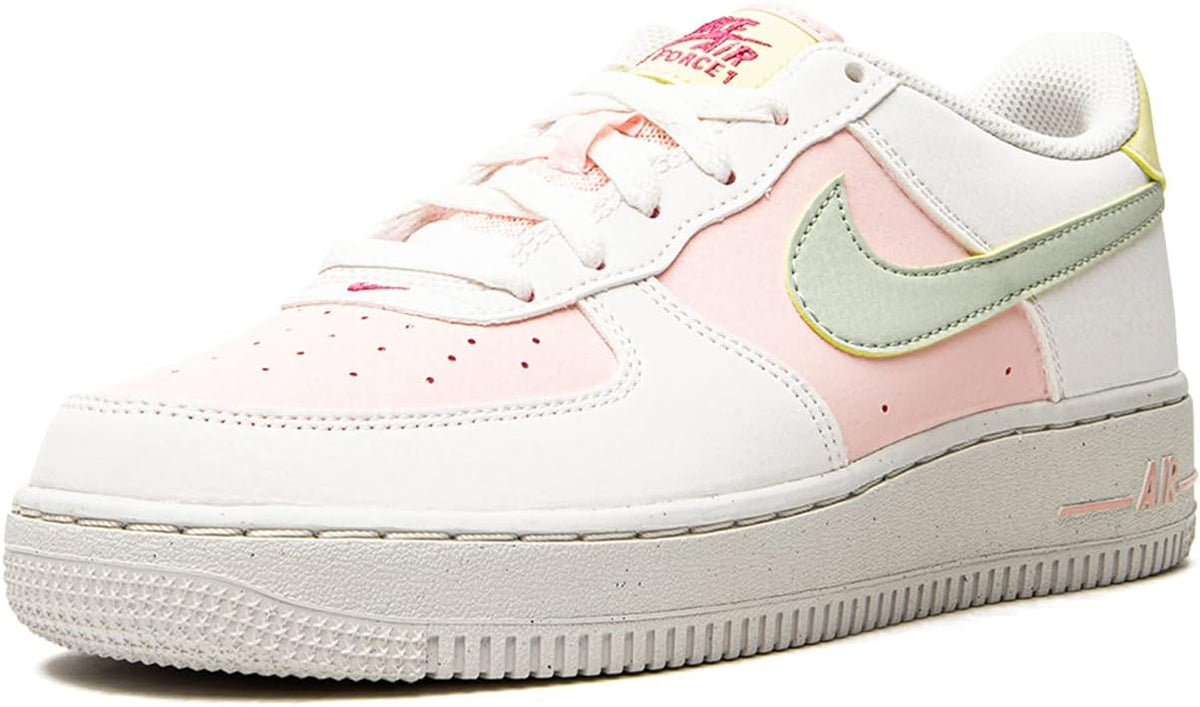 Big kid white sneakers with mint swoosh and pink side panel, lace-up style.