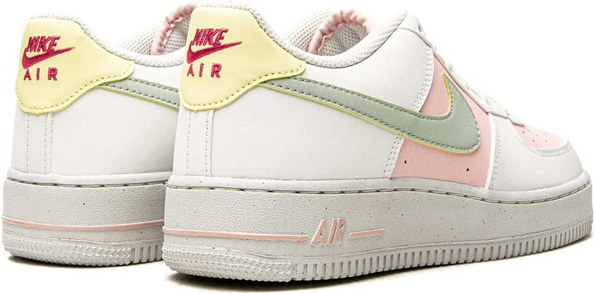 Big kid white sneakers with mint swoosh trim, pink heel panel, 'AIR' logo.