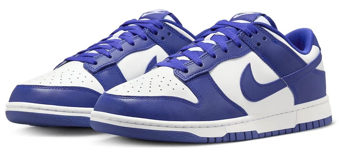 Nike Dunk Low retro sneakers, pair view with blue laces, white panels, blue swooshes