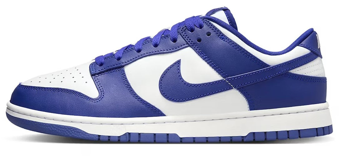 Nike Dunk Low retro sneakers, white and royal blue side profile with blue swoosh