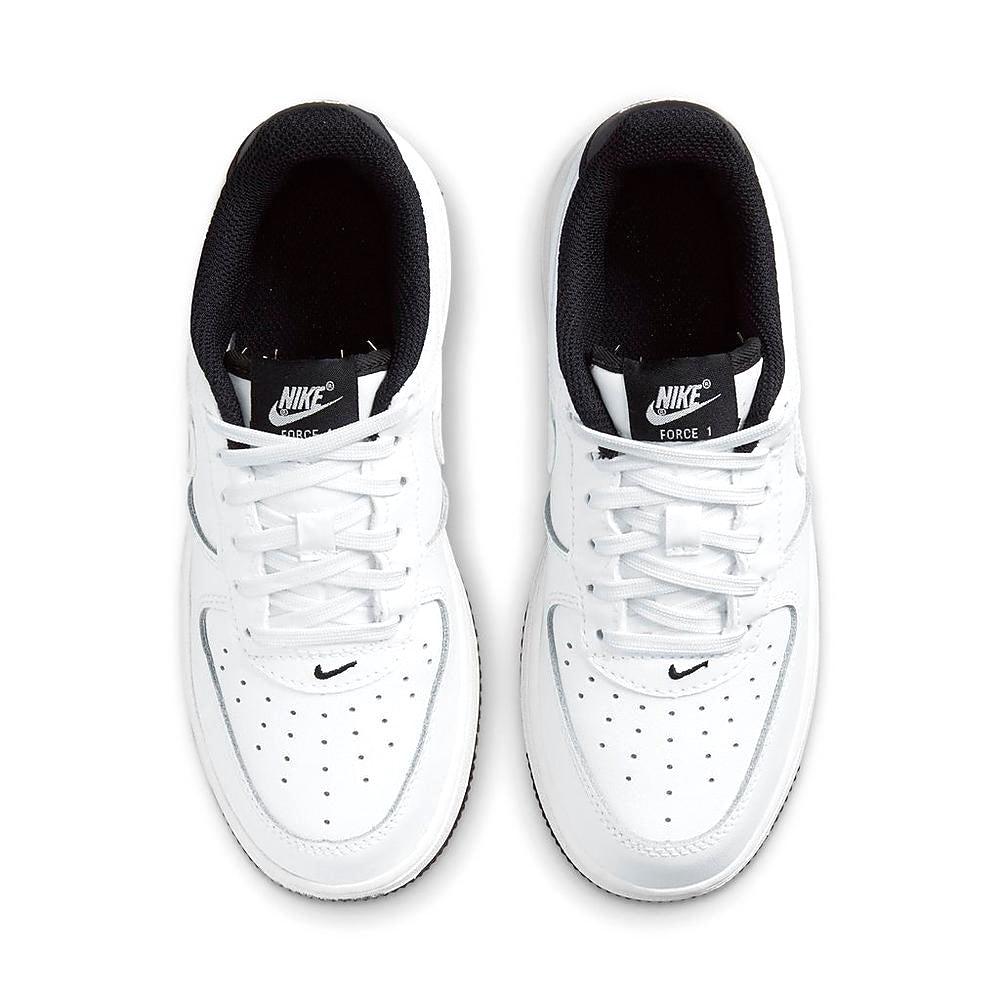 Nike Force 1 kids sneakers pair, white uppers with black lining and Nike branding on tongue