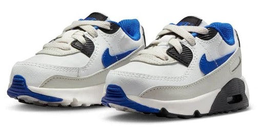 Pair of toddler white low-top sneakers with blue swooshes and black accents