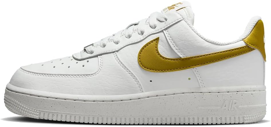 White Nike Air Force 1 low-top sneakers with gold Swoosh and AIR branding