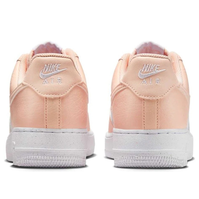 Back view of Women's Nike Air Force 1 sneakers, pale peach with NIKE AIR branding