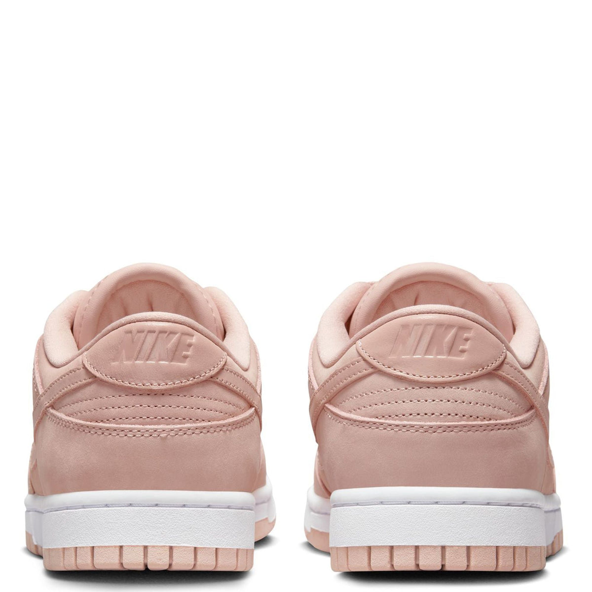 Pink Nike low-top sneakers, rear view with Nike heel logo and white sole