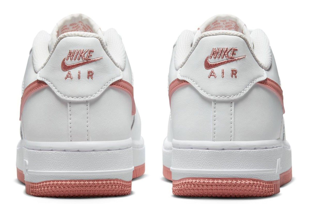 Kids' Nike low-top sneakers with red heel lining and Air logo on back tabs